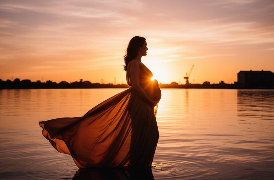 An epic moment of a pregnant woman silhouetted against a dramatic sunset over the Spotswood waterfront, showcasing a beautiful Spotswood maternity photoshoot scenic views.