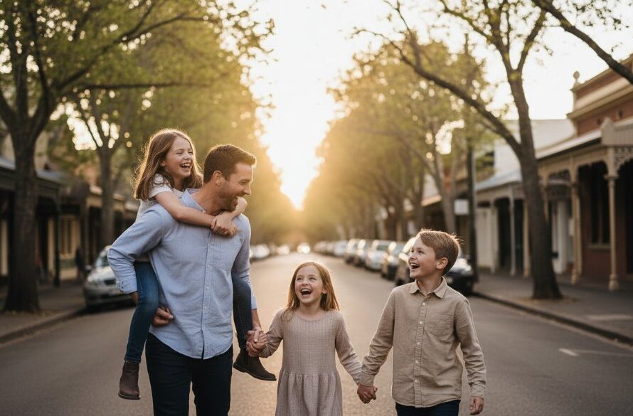 A candid, emotional moment captured during storytelling family portraits in Geelong West's urban charm, featuring a family laughing joyfully under dramatic golden hour light, with iconic Geelong West architecture subtly blurred in the background, professional colour grading.