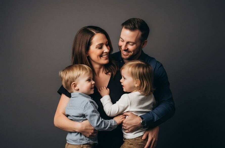A heartwarming, professionally lit studio portrait of a multi-generational family in Tooradin, joyfully embracing, capturing an epic moment of connection through Tooradin professional studio photography for bespoke family portraits, with soft, elegant backlighting and a focus on genuine expressions.