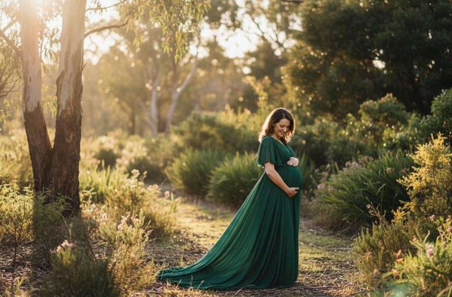 An expectant mother in a flowing gown cradled by natural light at sunset in a scenic Vermont Victoria outdoor maternity photoshoot, capturing a serene and powerful epic moment against a backdrop of lush Australian bushland.