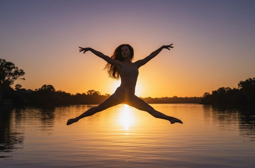 Dynamic shot of a ballet dancer mid-leap against a sunset over the Murray River in Cobram, showcasing vibrant Cobram dance photography for local studios, with dramatic backlighting and a powerful silhouette.