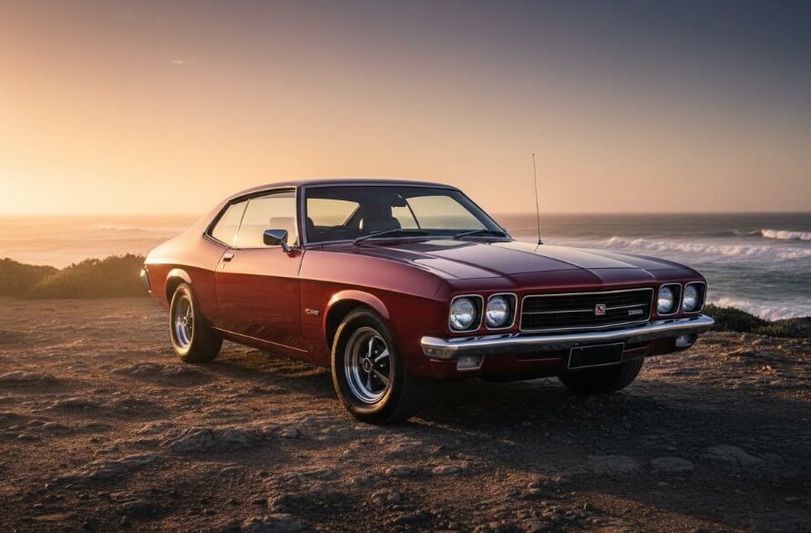 A dramatic sunset 'epic moment' photograph showcasing a highly polished vintage muscle car parked along the rugged Portland, Victoria coastline, with the golden hour light reflecting off its chrome, emphasizing the vehicle's classic lines during a Vintage Car Photoshoot Portland Victoria.