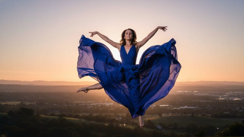 A dynamic and emotionally charged photograph capturing a dancer mid-air in an epic leap, silhouetted against a dramatic sunset over Waurn Ponds, showcasing Waurn Ponds vibrant dance photography for epic moments.