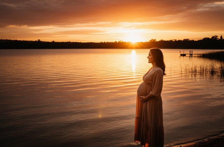 A stunning Wendouree maternity photography golden hour portraits showcasing an expectant mother silhouetted against a radiant sunset over Lake Wendouree, capturing her beautiful baby bump in a breathtaking and emotional moment.