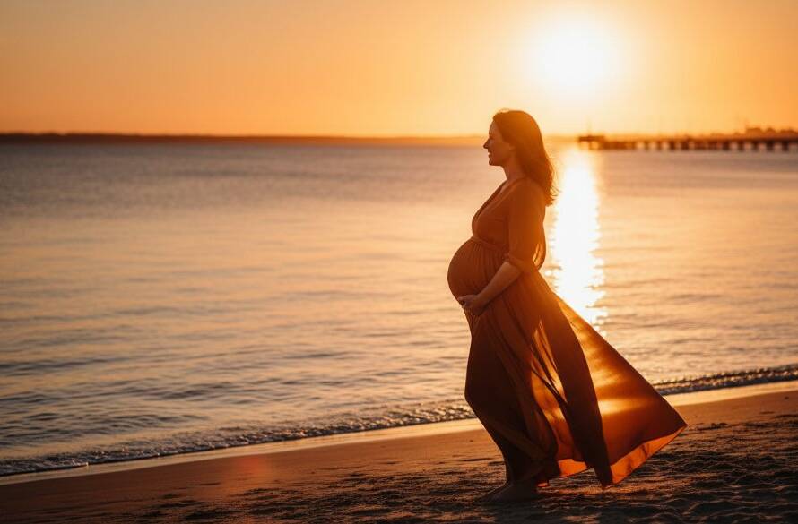 A breathtaking epic moment captured with Werribee South Golden Hour Maternity Photography, featuring a radiant pregnant woman silhouetted against a dramatic sunset over the Werribee South coastline, her hand gently cradling her baby bump, with golden light reflecting on the water.