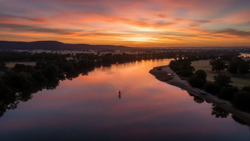 An epic moment captured by Wodonga drone photography breathtaking aerial views, showcasing a golden sunset over the Murray River in Wodonga, highlighting local architecture and natural beauty from a dramatic high angle, professionally colour graded.