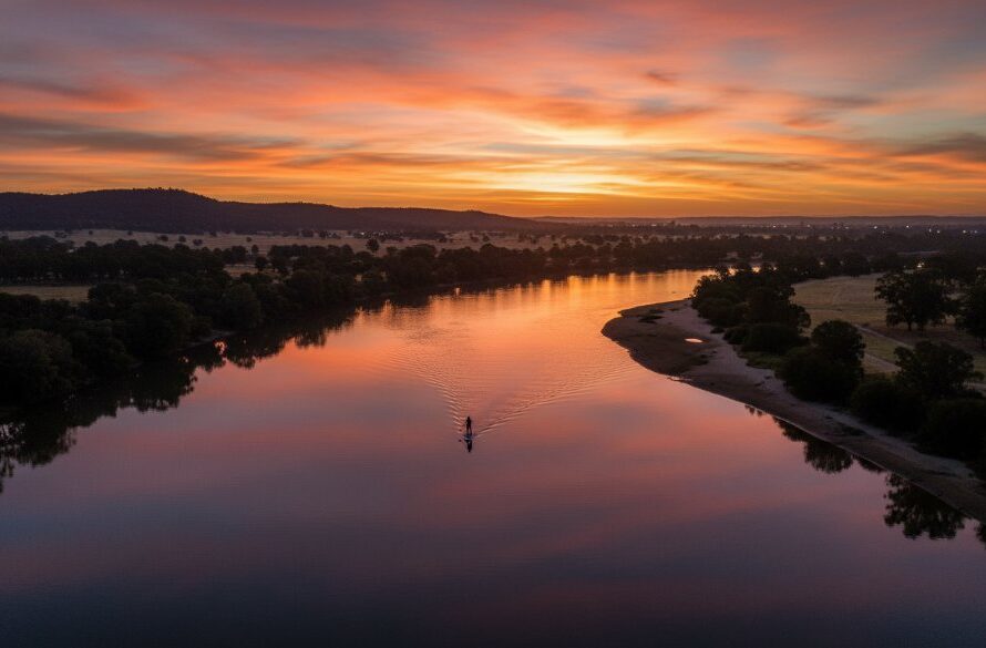An epic moment captured by Wodonga drone photography breathtaking aerial views, showcasing a golden sunset over the Murray River in Wodonga, highlighting local architecture and natural beauty from a dramatic high angle, professionally colour graded.