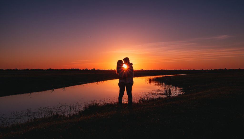 A dramatic wide shot showcasing a family's tender embrace at sunset near Skeleton Creek in Wyndham Vale, Victoria, bathed in golden light, embodying the essence of Wyndham Vale Victoria Fine Art Storytelling Photography with a cinematic, emotive feel.