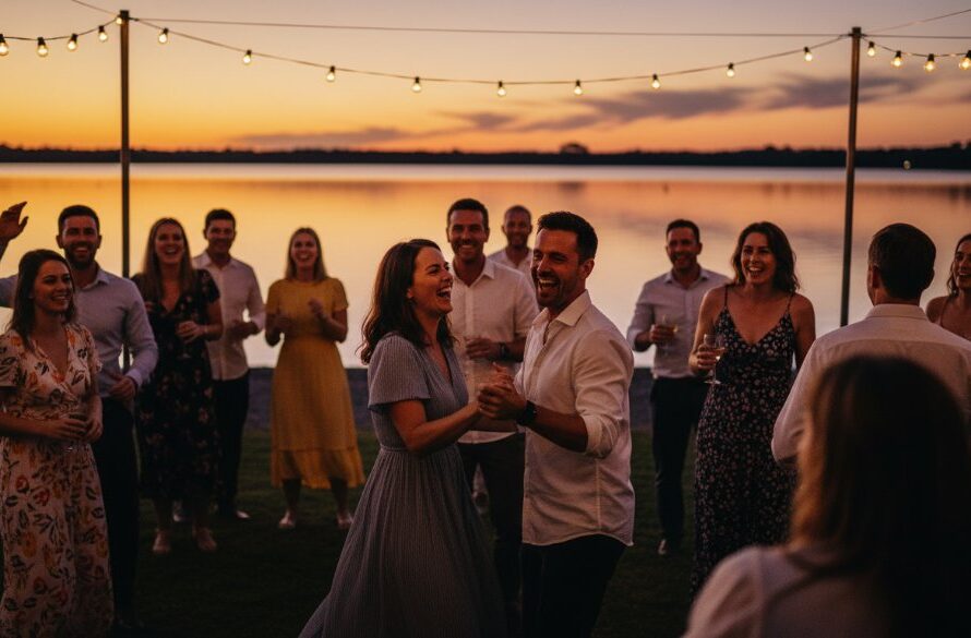 An epic moment of joyful guests dancing under string lights at a twilight lakeside party in Yarrawonga, professionally captured by Yarrawonga party photography capturing vibrant lakeside celebrations, with stunning dramatic lighting and rich colour grading.